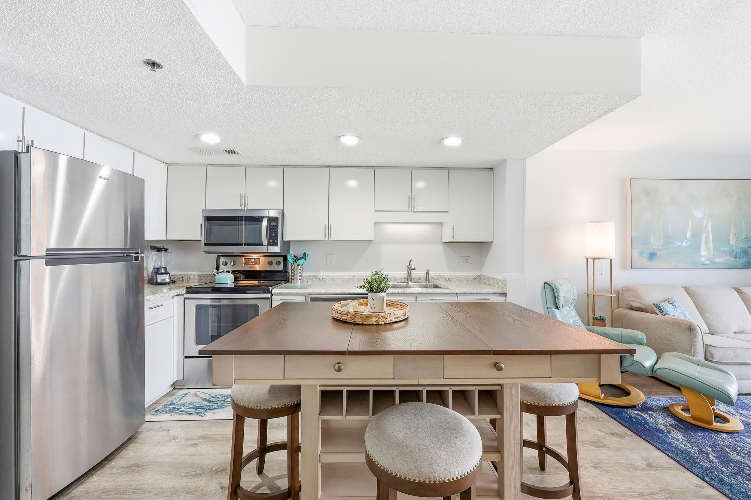 920 North Waccamaw Drive, Unit 2305 Murrells Inlet, SC 29576 - Photo 9 of 40 Kitchen featuring appliances with stainless steel finishes, light wood-style floors, white cabinets, a textured ceiling, and recessed lighting