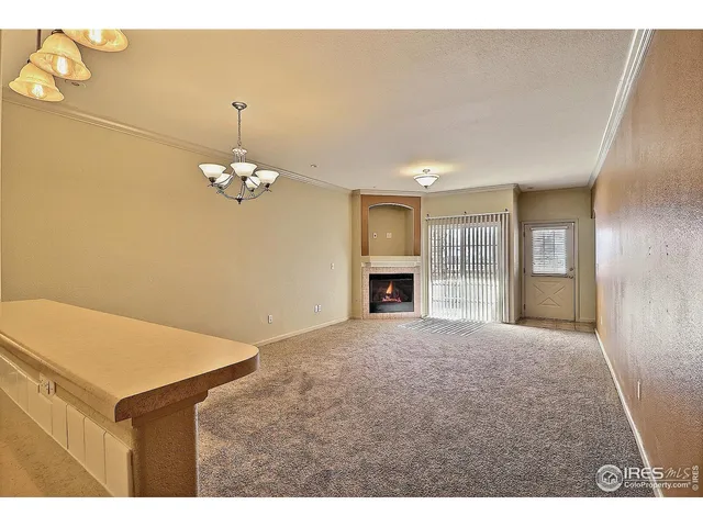 a view of an empty room with a fireplace