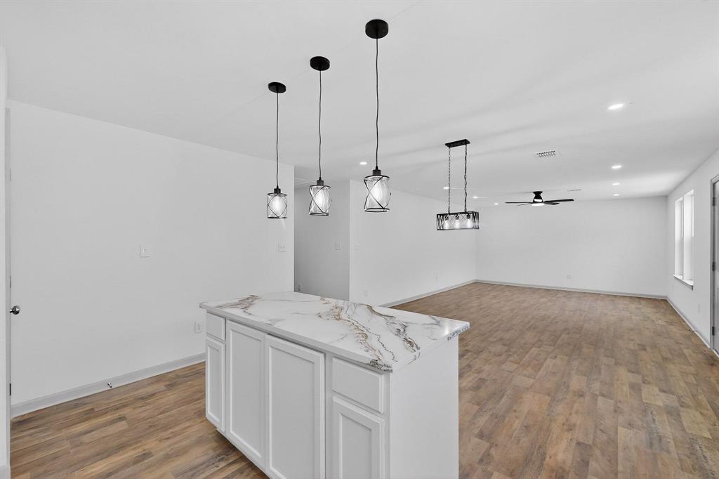 5650 Forney Road Dallas, TX 75227 - Photo 11 of 39 a spacious bathroom with a granite countertop sink and a mirror