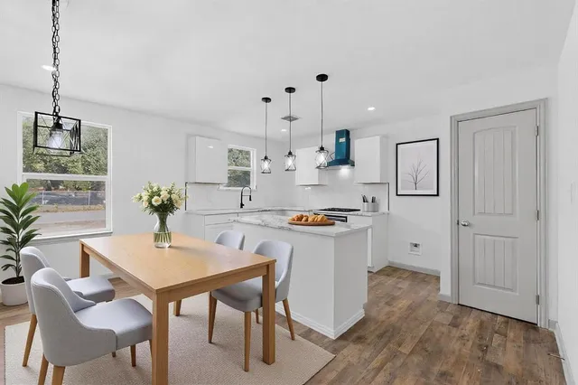 a kitchen with refrigerator and cabinets