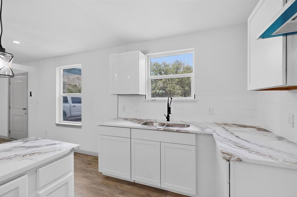5650 Forney Road Dallas, TX 75227 - Photo 16 of 39 a kitchen with a granite countertop sink and window