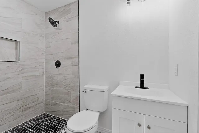 a bathroom with a sink toilet and shower