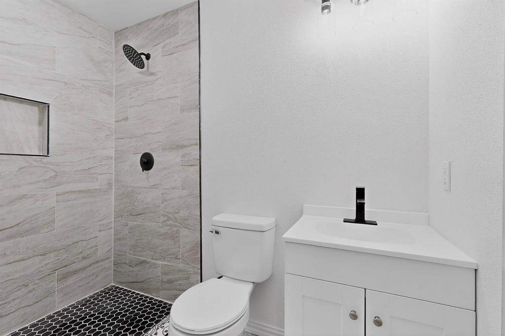 5650 Forney Road Dallas, TX 75227 - Photo 19 of 39 a bathroom with a sink toilet and shower