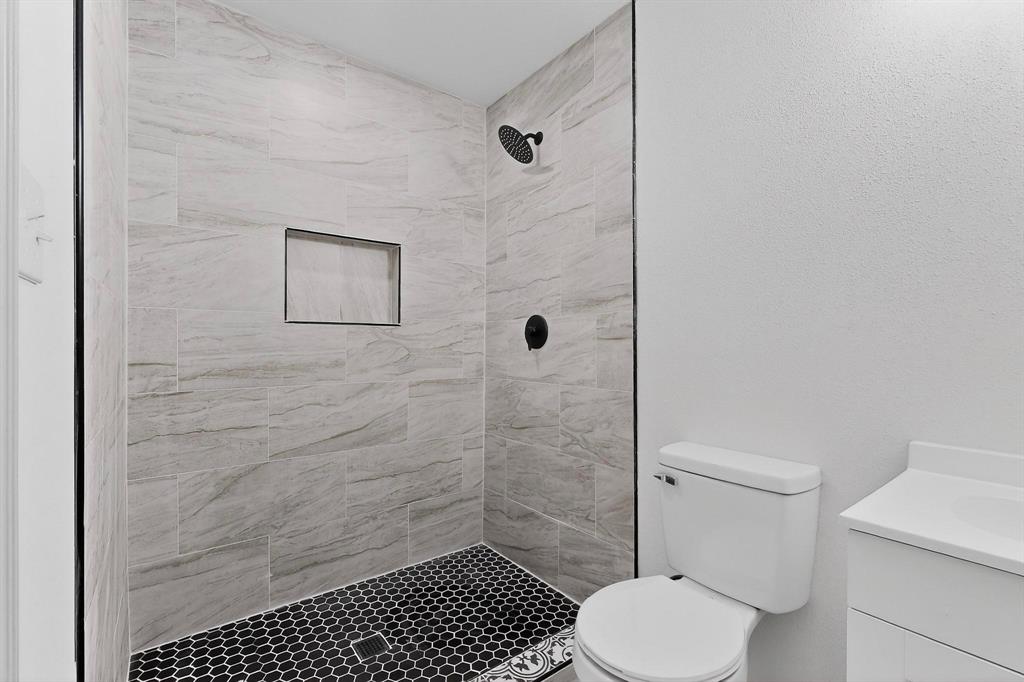 5650 Forney Road Dallas, TX 75227 - Photo 20 of 39 a bathroom with a toilet and a shower