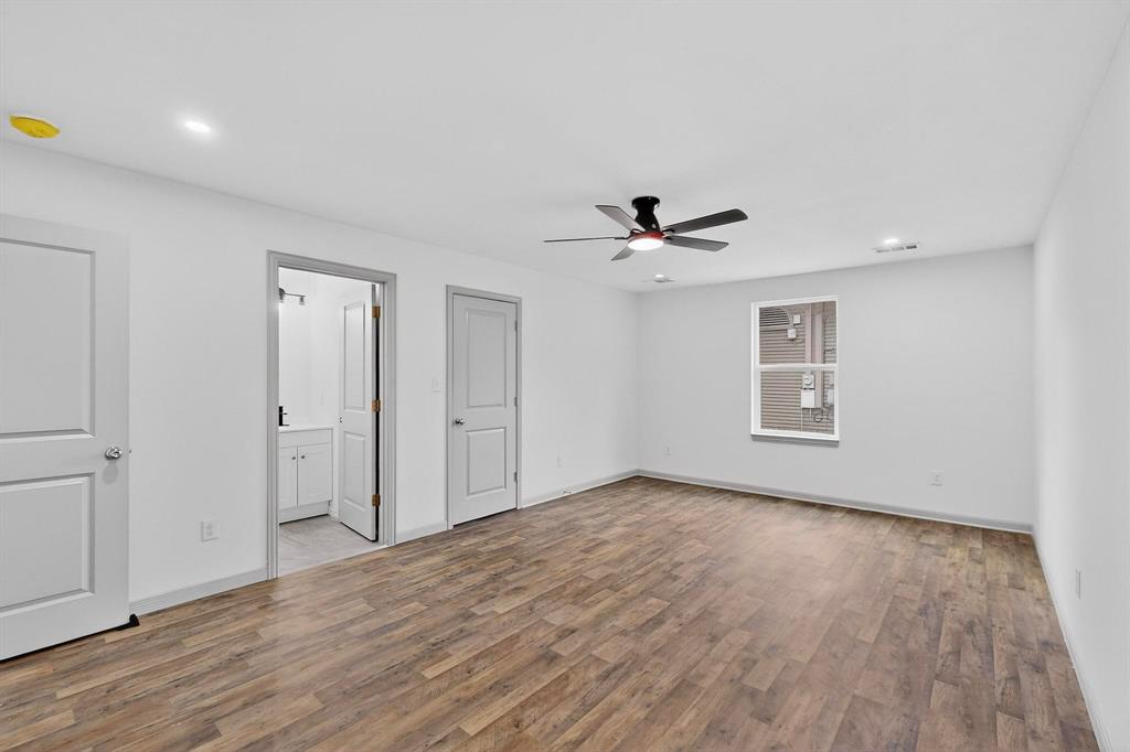 5650 Forney Road Dallas, TX 75227 - Photo 22 of 39 a view of empty room with wooden floor and fan