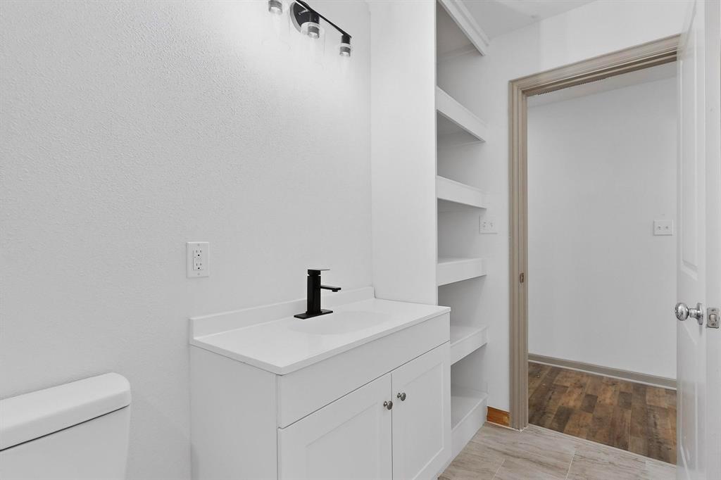 5650 Forney Road Dallas, TX 75227 - Photo 24 of 39 a bathroom with a sink a toilet and shower