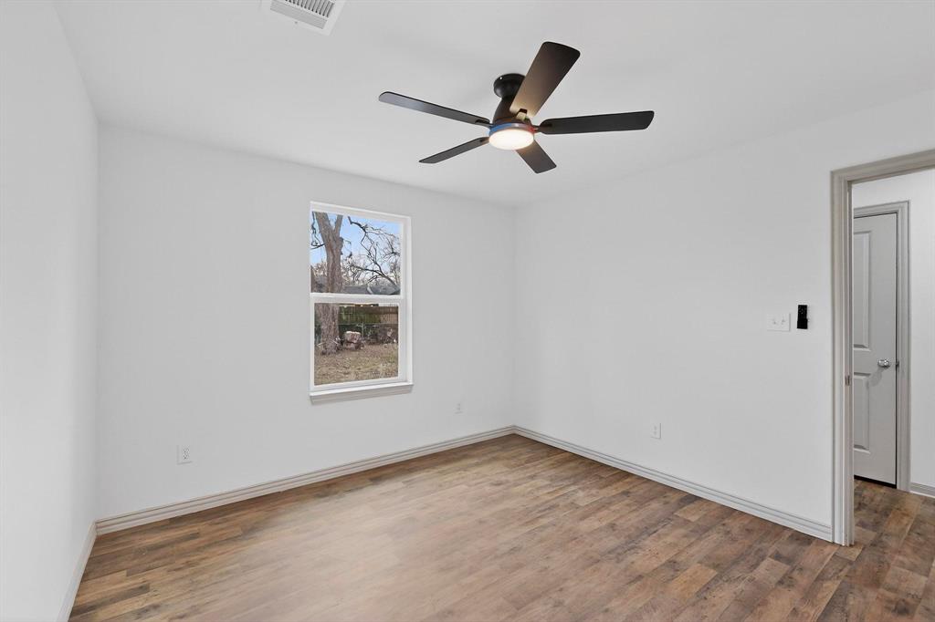 5650 Forney Road Dallas, TX 75227 - Photo 28 of 39 a view of a big room with wooden floor and windows