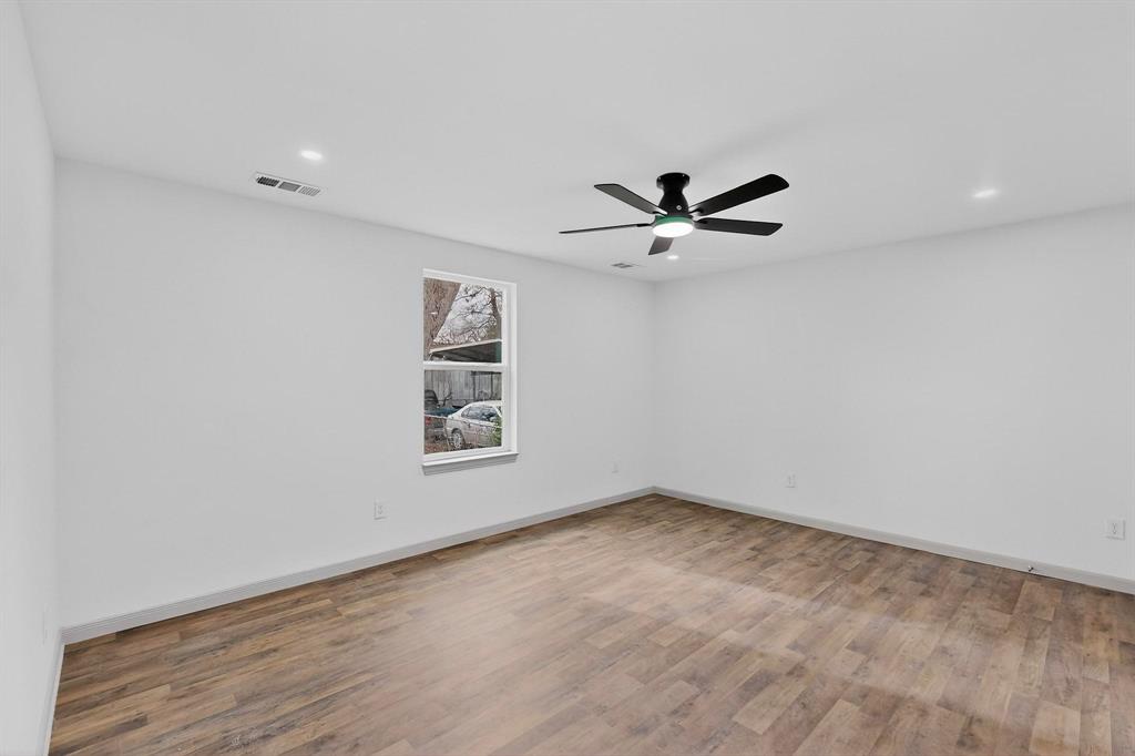 5650 Forney Road Dallas, TX 75227 - Photo 29 of 39 a view of a room with a ceiling fan and wooden floor