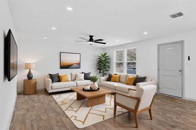 a living room with furniture and a large window