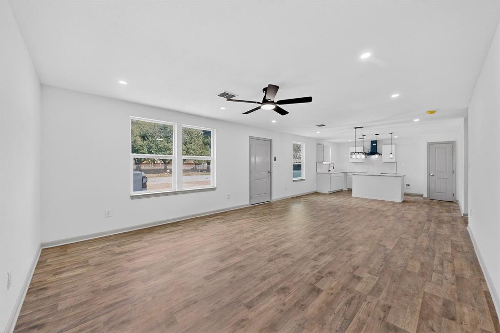 5650 Forney Road Dallas, TX 75227 - Photo 8 of 39 a view of empty room with wooden floor and window