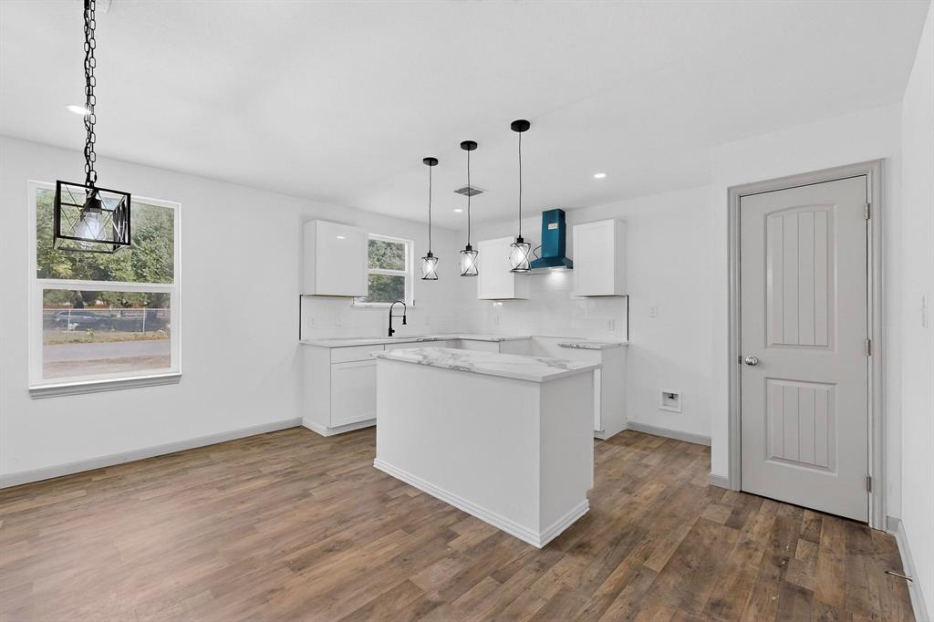 5650 Forney Road Dallas, TX 75227 - Photo 10 of 39 a kitchen with a sink cabinets and wooden floor