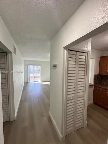 a view of hallway with wooden floor
