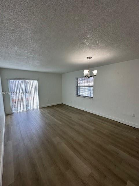 1015 Northwest 45th Avenue, Unit 101 Miami, FL 33126 - Photo 5 of 17 a view of an empty room with wooden floor and a window