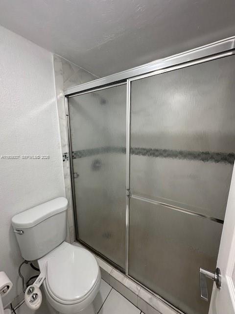 1015 Northwest 45th Avenue, Unit 101 Miami, FL 33126 - Photo 10 of 17 a white toilet sitting next to a shower