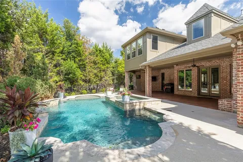 a backyard of a house with table and chairs