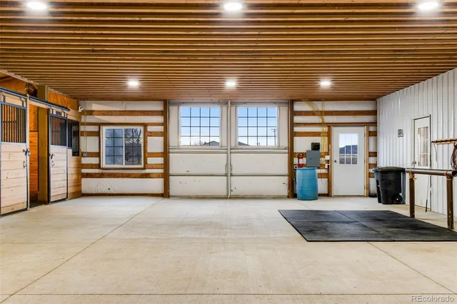 a view of an empty room with wooden cabinets