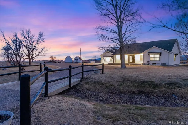 a view of a yard with snow in the background