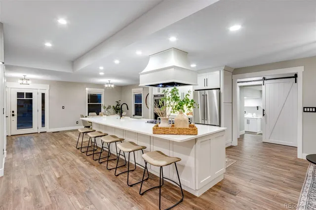 a kitchen with stainless steel appliances a sink and a refrigerator