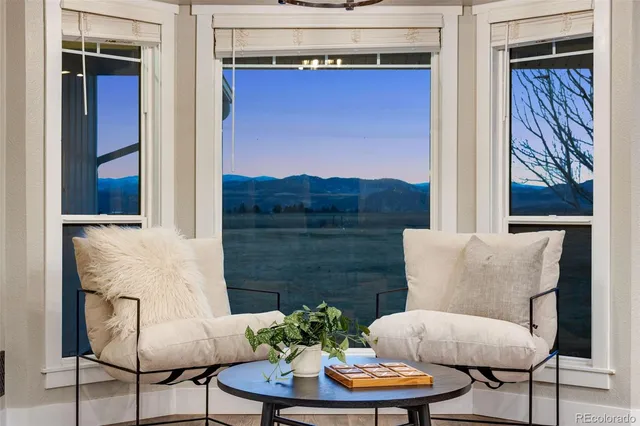 a living room with furniture kitchen view and a table