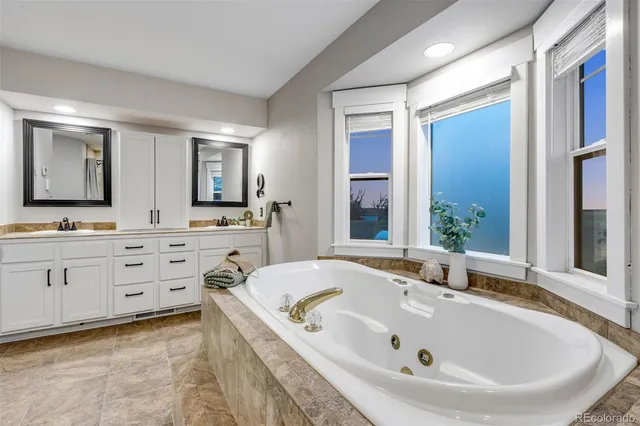 a bathroom with a tub and a shower