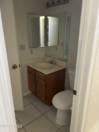 a bathroom with a toilet a sink and mirror