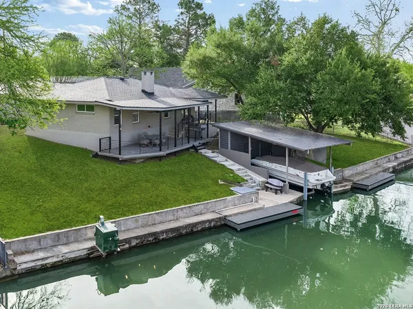 an aerial view of a house with swimming pool having outdoor seating