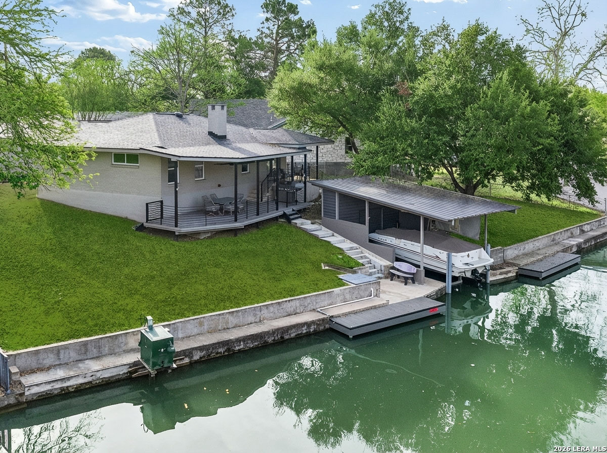 an aerial view of a house with swimming pool having outdoor seating
