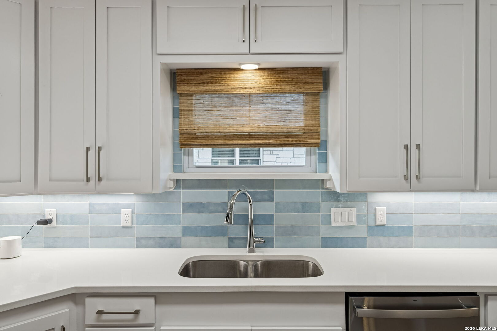 119 Robin Road Highland Haven, TX 78654 - Photo 16 of 33 a kitchen with granite countertop white cabinets and a sink