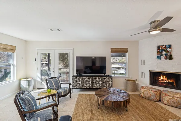 a living room with furniture a fireplace and a flat screen tv