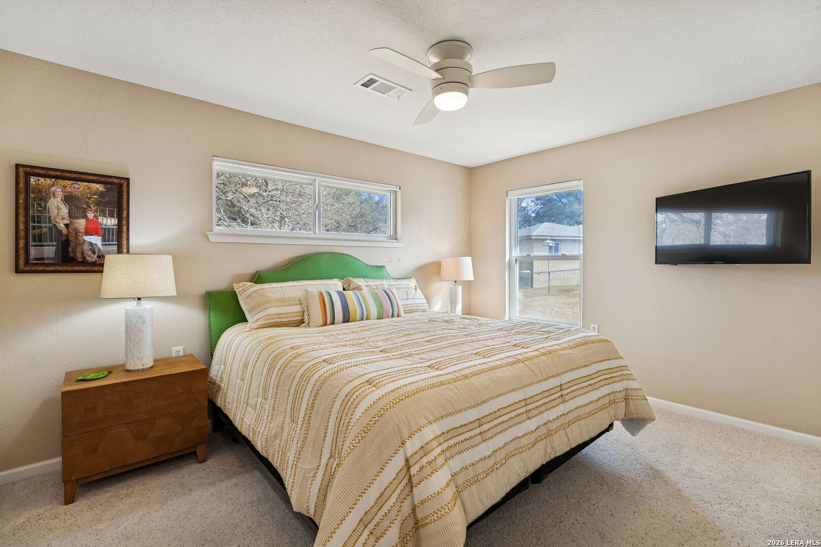 119 Robin Road Highland Haven, TX 78654 - Photo 23 of 33 a bedroom with a bed a couch and a flat screen tv