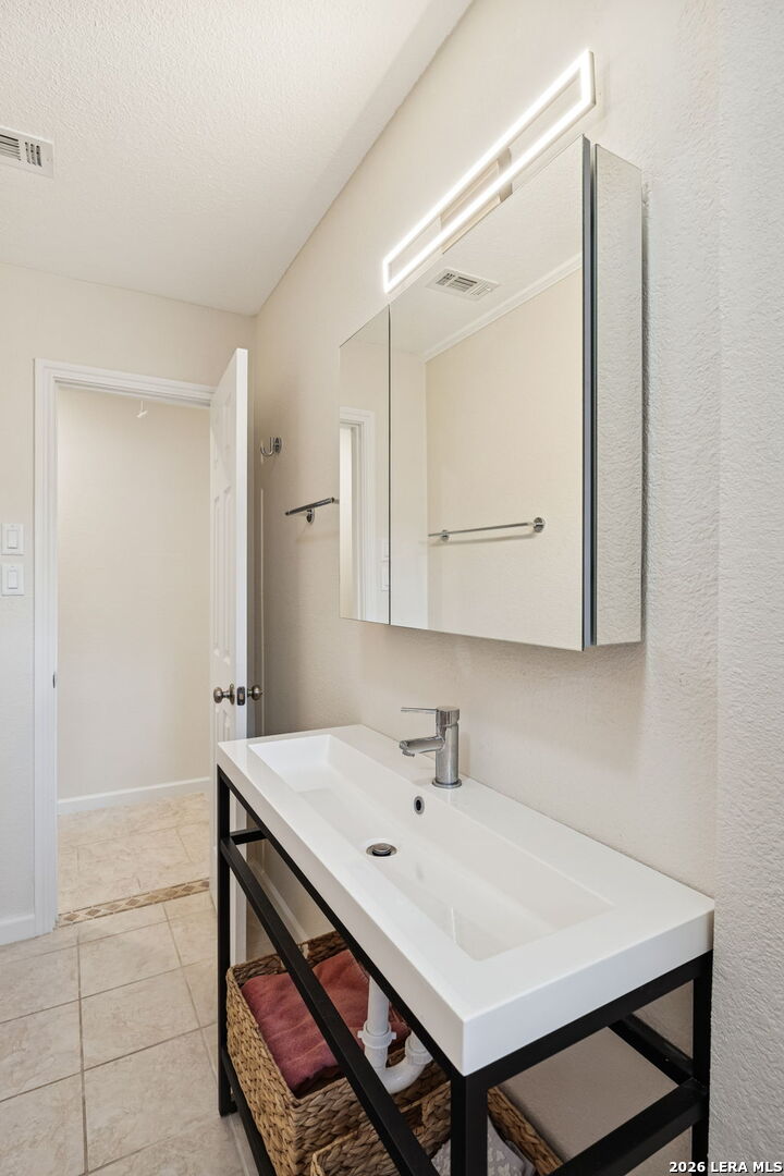 119 Robin Road Highland Haven, TX 78654 - Photo 24 of 33 a bathroom with a sink a mirror and a vanity