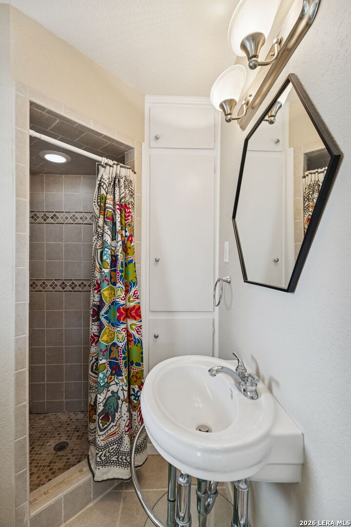 119 Robin Road Highland Haven, TX 78654 - Photo 30 of 33 a bathroom with a sink mirror and shower
