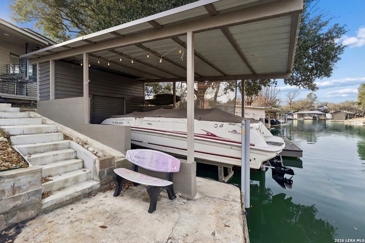 119 Robin Road Highland Haven, TX 78654 - Photo 4 of 33 a view of a patio with table and chairs with wooden floor and fence