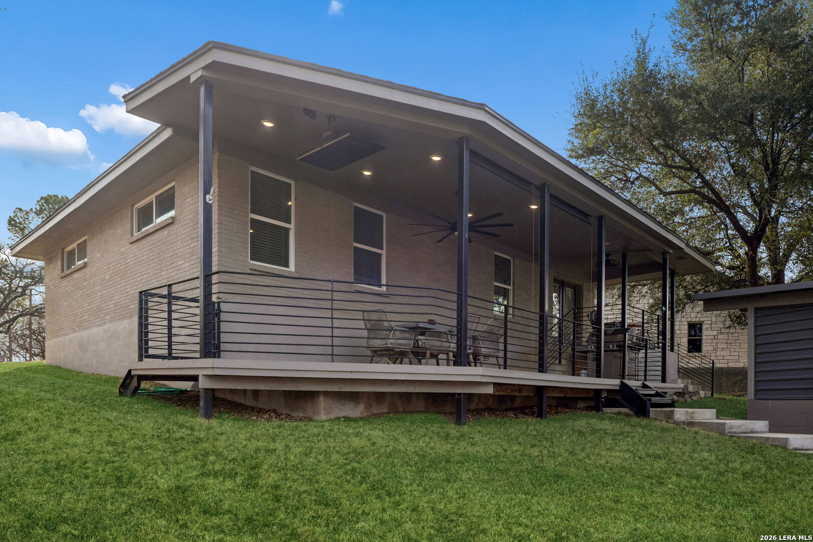 119 Robin Road Highland Haven, TX 78654 - Photo 8 of 33 a front view of a house with a garden