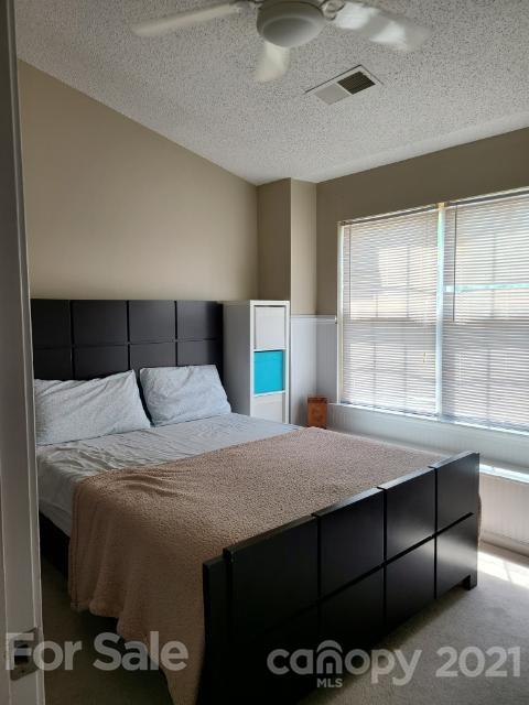 205 Butler Place Fort Mill, SC 29715 - Photo 2 of 13 a bedroom with a bed and a large window