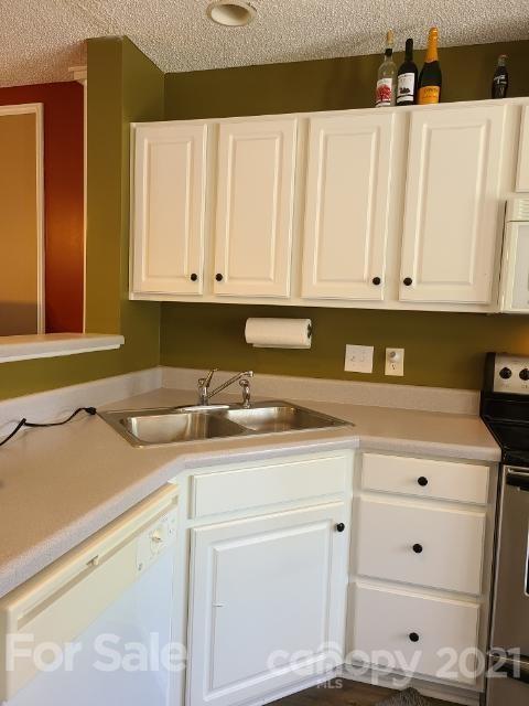 205 Butler Place Fort Mill, SC 29715 - Photo 6 of 13 a kitchen with granite countertop white cabinets and sink