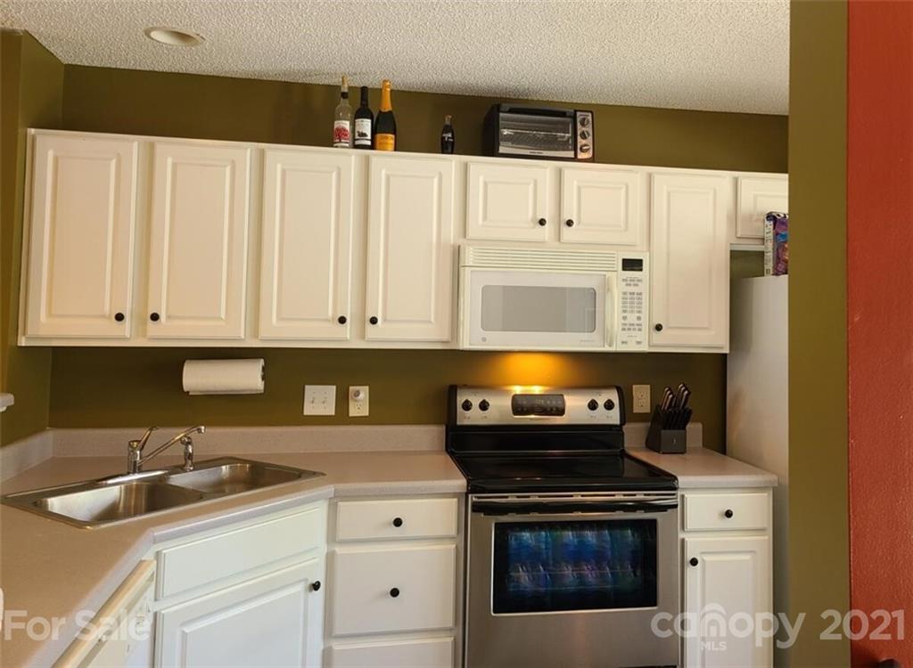 205 Butler Place Fort Mill, SC 29715 - Photo 8 of 13 a kitchen with a sink and a stove