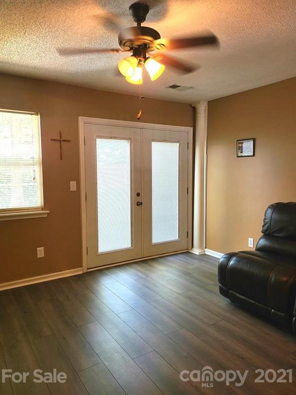 205 Butler Place Fort Mill, SC 29715 - Photo 9 of 13 a view of an empty room with window and wooden floor