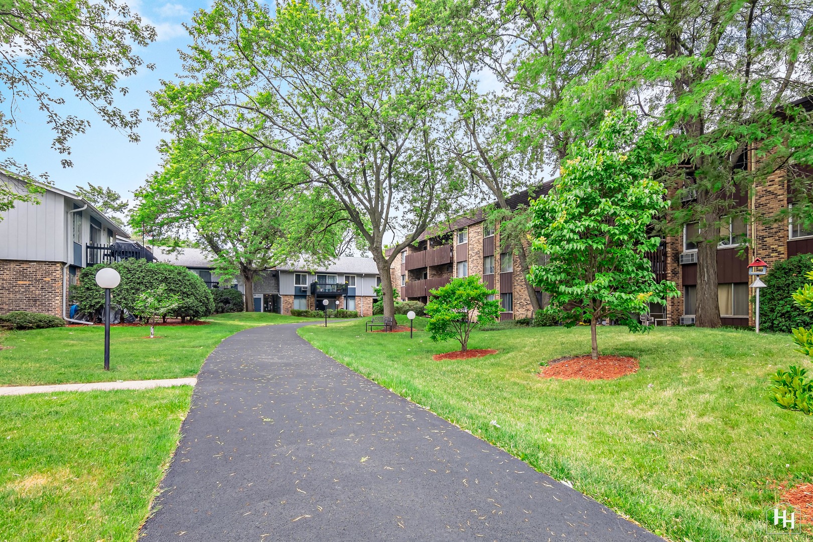 940 East Old Willow Road, Unit 206 Prospect Heights, IL 60070 - Photo 23 of 25 a view of a house with a big yard and large trees