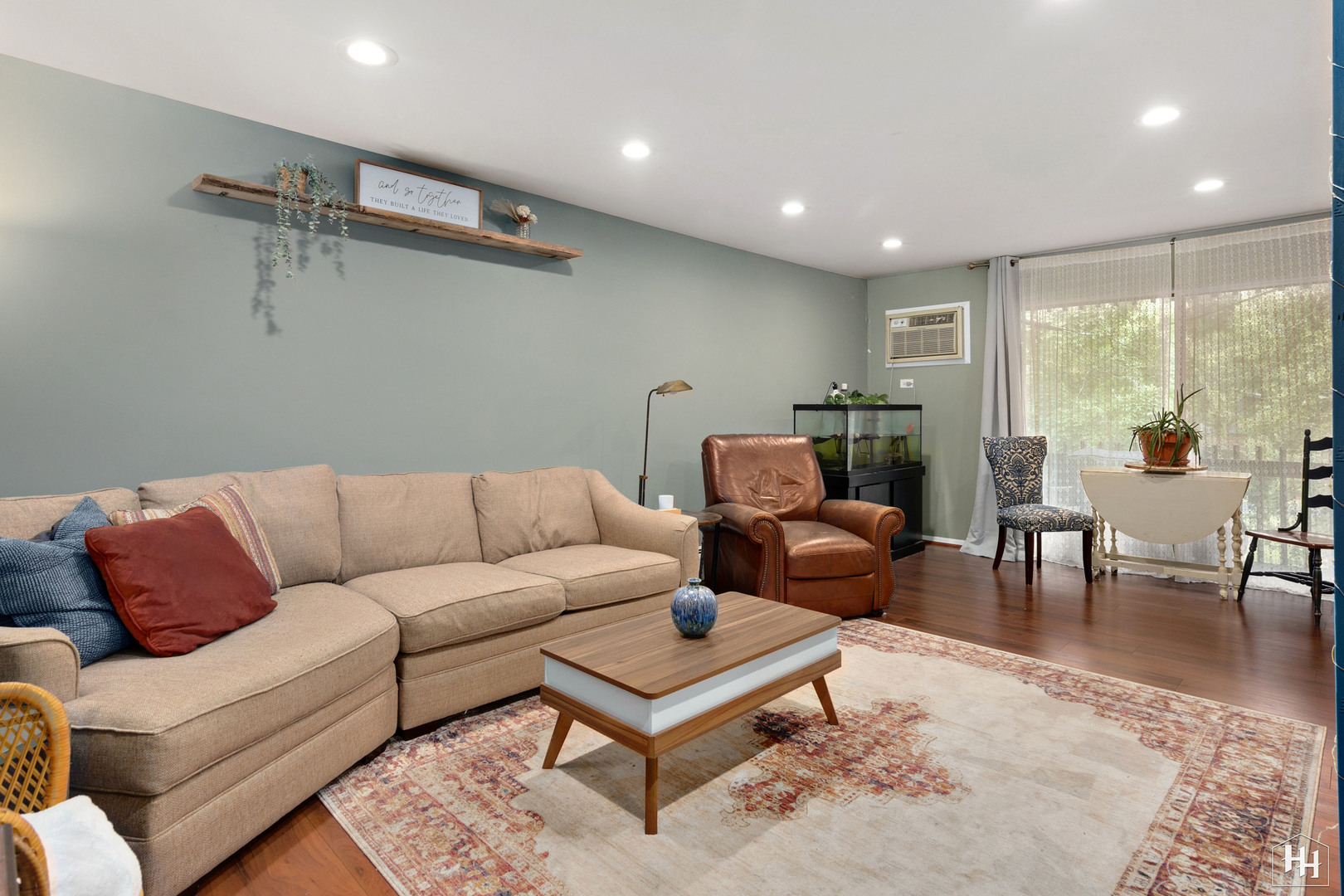 940 East Old Willow Road, Unit 206 Prospect Heights, IL 60070 - Photo 3 of 25 a living room with furniture a rug and a floor to ceiling window