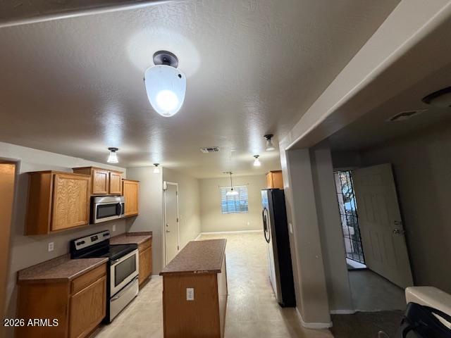 307 South Carter Ranch Road Coolidge, AZ 85128 - Photo 2 of 17 a kitchen with stainless steel appliances granite countertop a refrigerator and a stove top oven