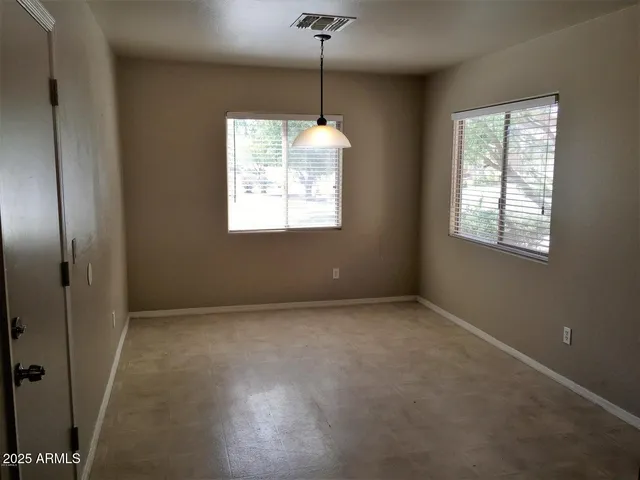 en empty room with windows and entrance