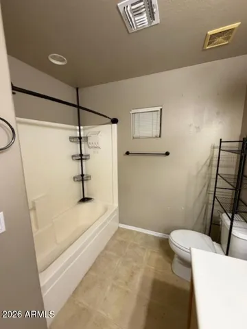 a bathroom with a shower and toilet