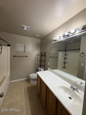 a bathroom with a sink a toilet and mirror