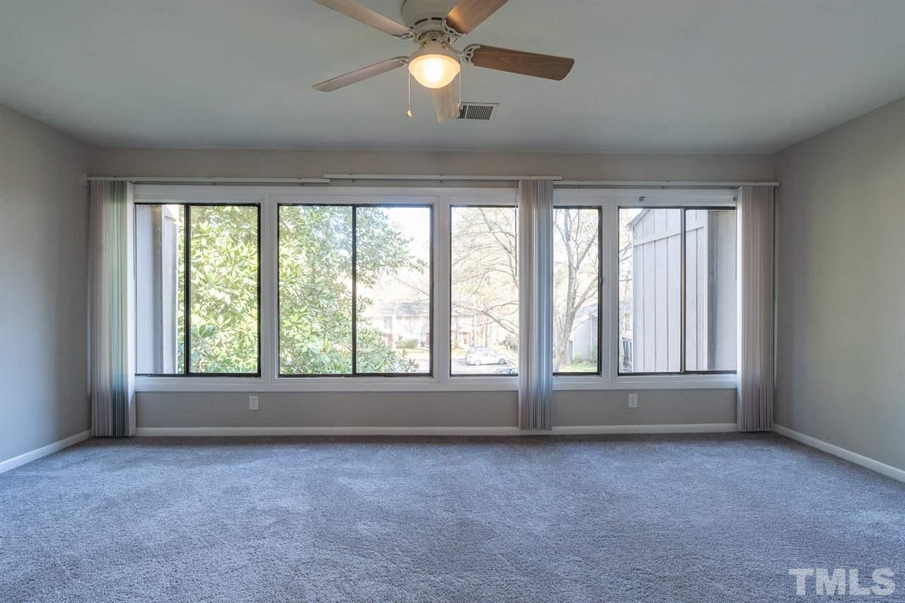 1762 Quail Ridge Road Raleigh, NC 27609 - Photo 14 of 28 an empty room with a window and ceiling fan
