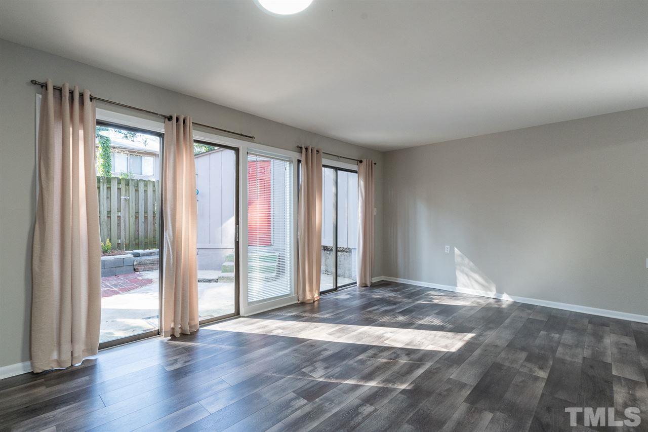 1762 Quail Ridge Road Raleigh, NC 27609 - Photo 8 of 28 wooden floor in an empty room with a window