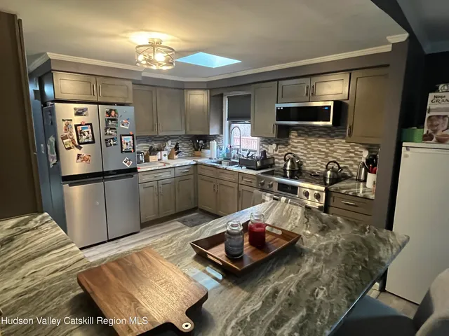 a kitchen with sink and refrigerator