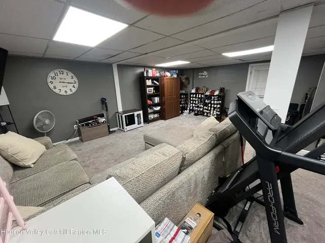 a living room with furniture a air conditioner vent and a window