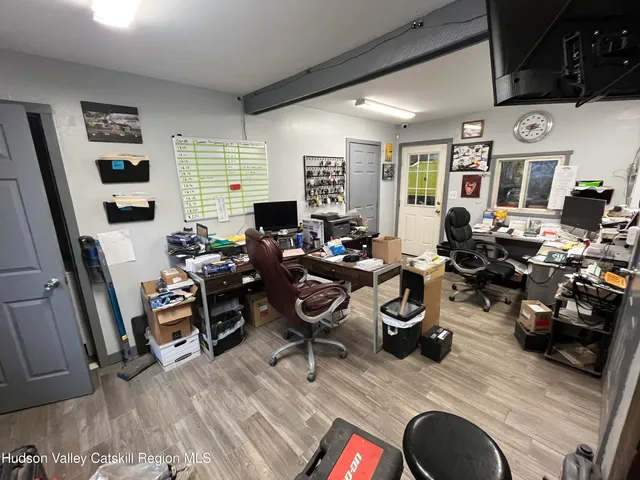 a living room with furniture a flat screen tv and a large window