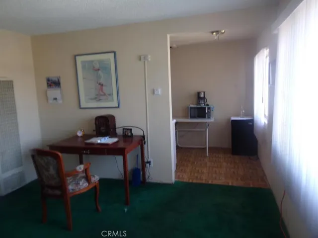 a workspace room with furniture and a window